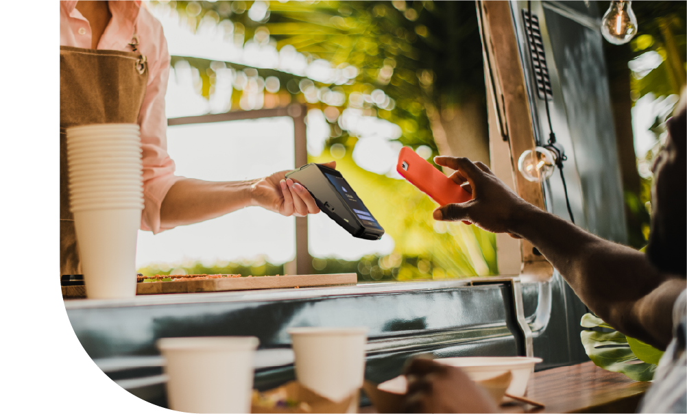 Merchant accepting a contactless mobile payment with a handheld card terminal